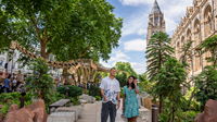 Two people walking through East Lawn of the Natural History Museum