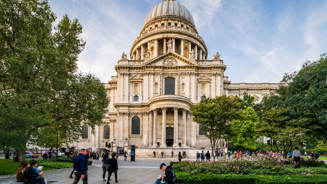 People walking about in front of St Paul's cathedral.