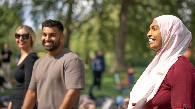 Three London & Partners staff members smile and laugh at the annual company picnic