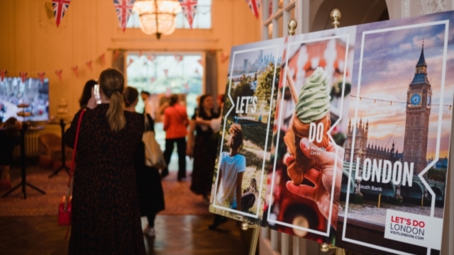 Let's Do London campaign press event in Berlin featuring guests and creative campaign board.