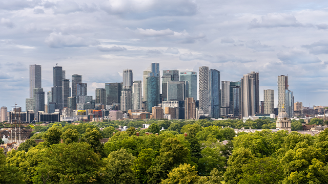 Panoramic shot of the London skyline and trees of Greenwich Park