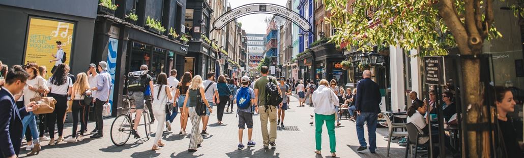 People walking past shops on London's Carnaby Street.